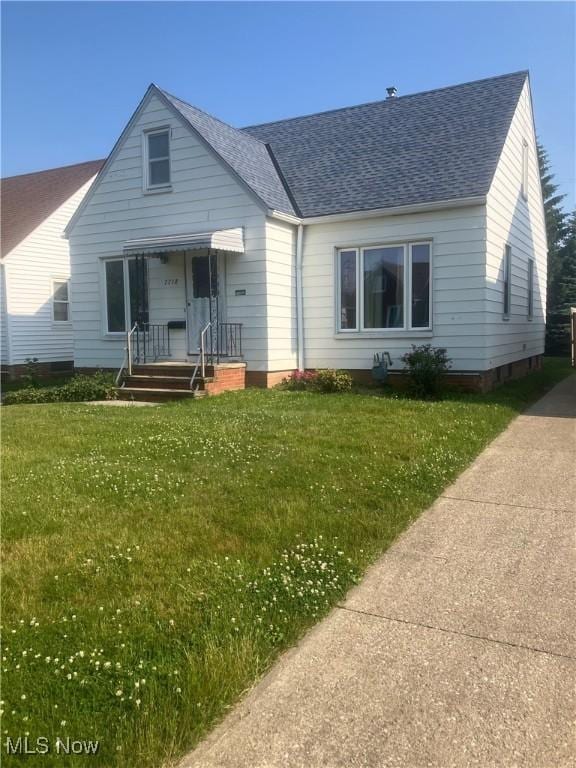 7718 Bertha Ave, Parma, OH 44129 - bungalow-style house with roof with shingles and a front yard