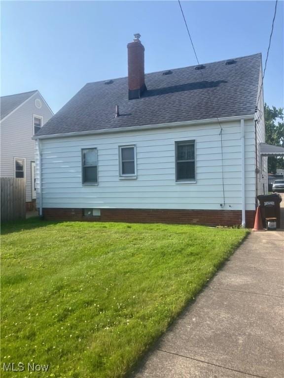 7718 Bertha Ave, Parma, OH 44129 - back of property with a chimney and roof with shingles