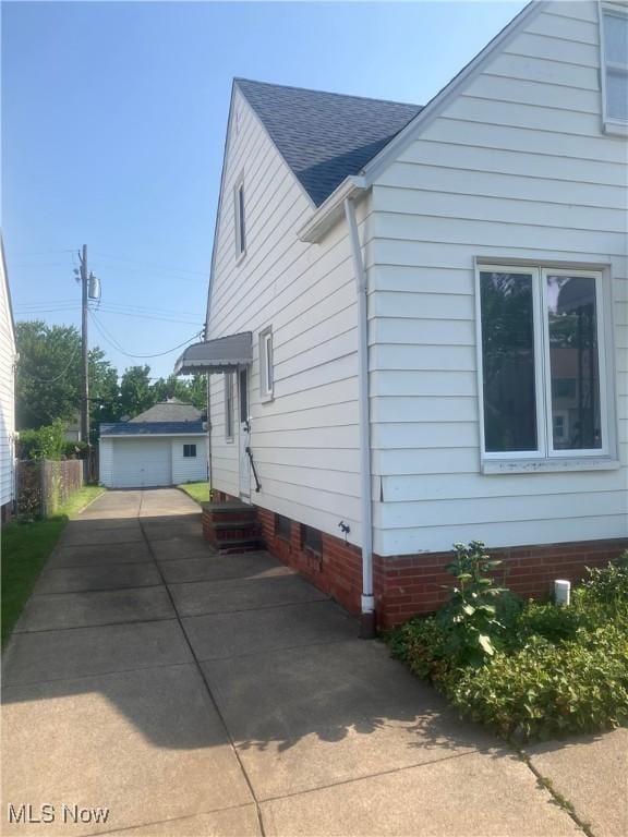 7718 Bertha Ave, Parma, OH 44129 - view of side of home with roof with shingles and a detached garage