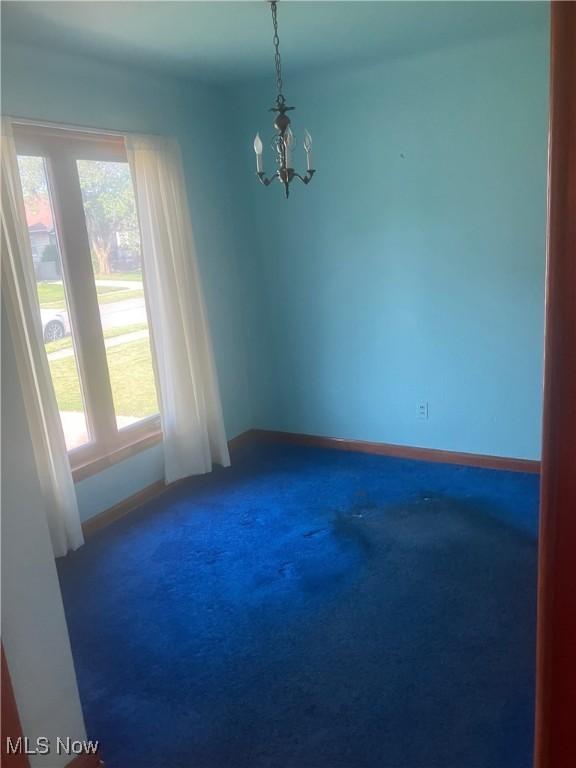 7718 Bertha Ave, Parma, OH 44129 - carpeted empty room featuring a chandelier and baseboards