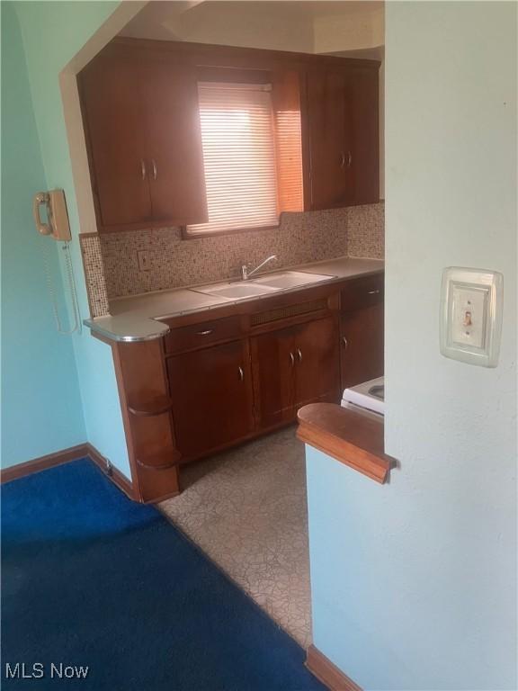 7718 Bertha Ave, Parma, OH 44129 - kitchen with tasteful backsplash and light countertops
