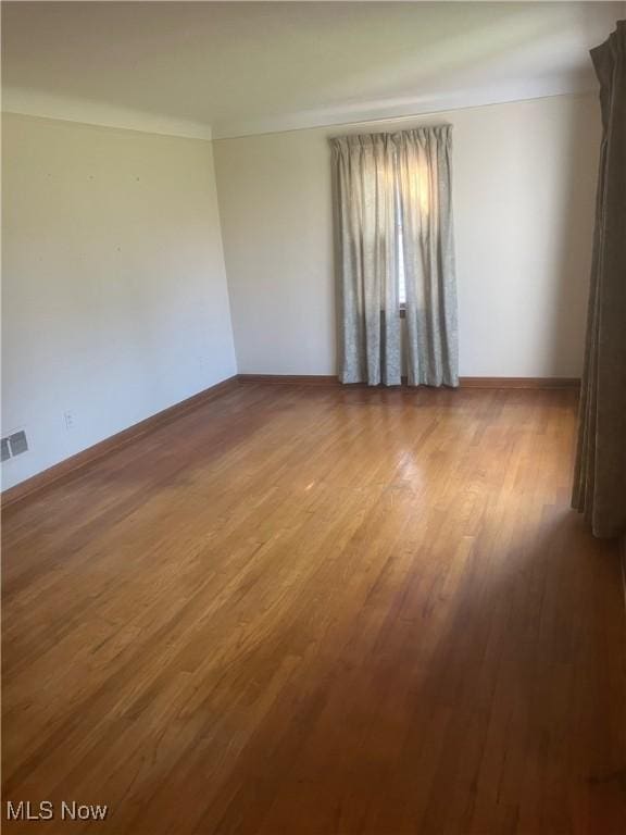 7718 Bertha Ave, Parma, OH 44129 - empty room with wood finished floors and baseboards