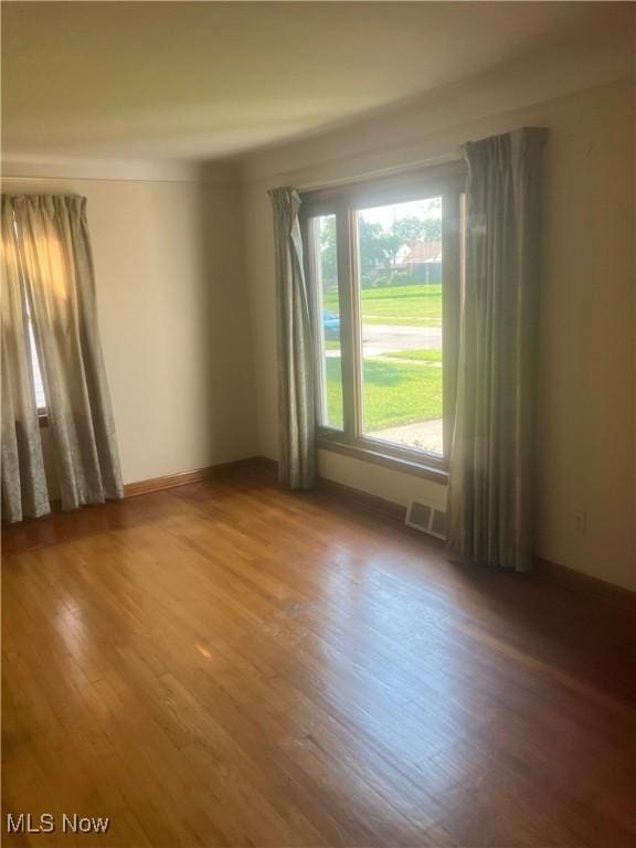7718 Bertha Ave, Parma, OH 44129 - empty room with wood finished floors and baseboards