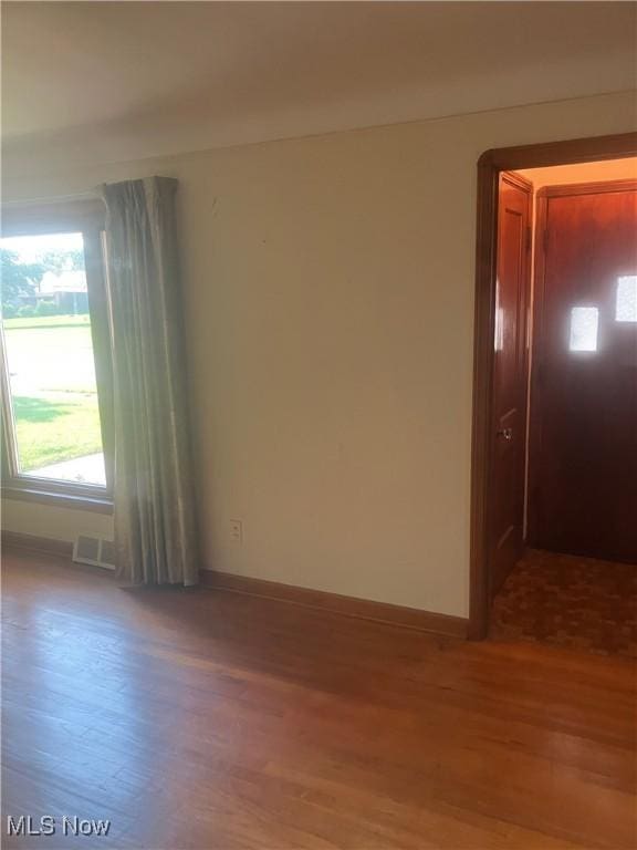 7718 Bertha Ave, Parma, OH 44129 - empty room with wood finished floors and baseboards