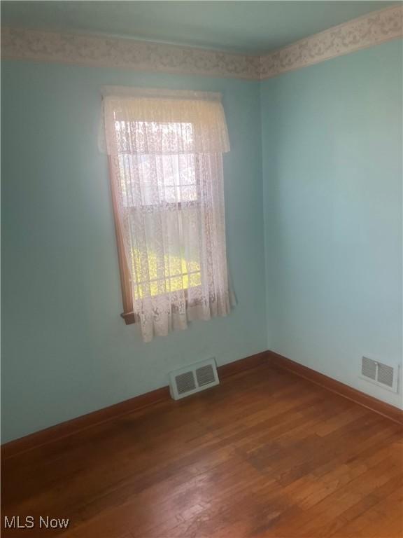 7718 Bertha Ave, Parma, OH 44129 - unfurnished room featuring wood finished floors