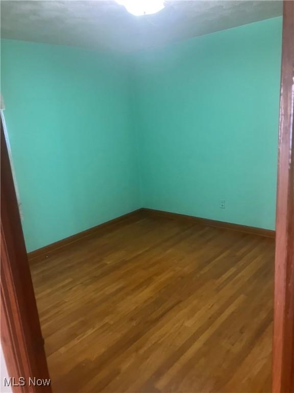 7718 Bertha Ave, Parma, OH 44129 - spare room with wood finished floors and baseboards