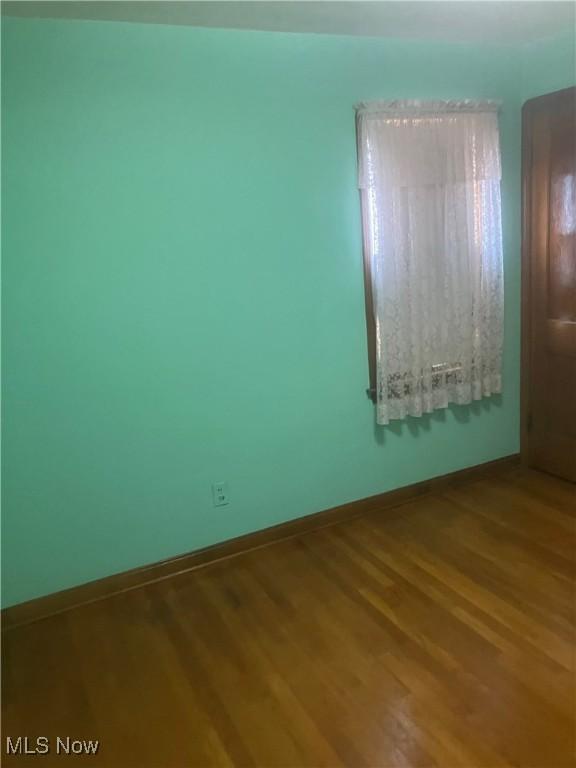 7718 Bertha Ave, Parma, OH 44129 - unfurnished room with wood finished floors and baseboards