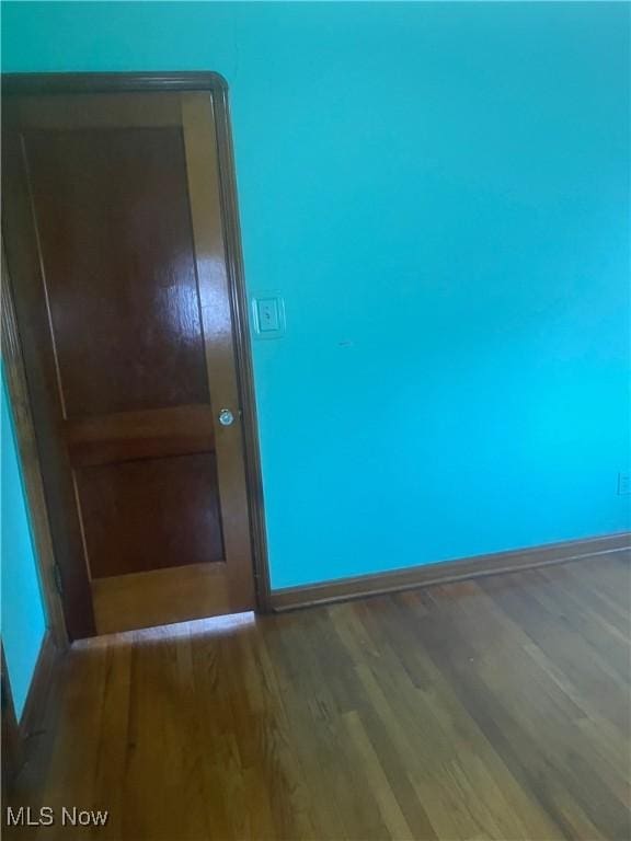 7718 Bertha Ave, Parma, OH 44129 - empty room featuring wood finished floors and baseboards