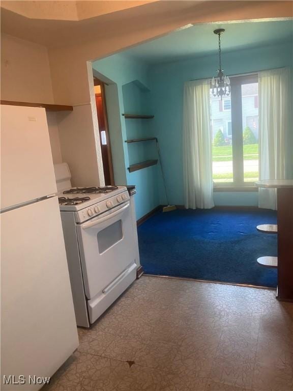 7718 Bertha Ave, Parma, OH 44129 - kitchen with white appliances, a chandelier, and pendant lighting