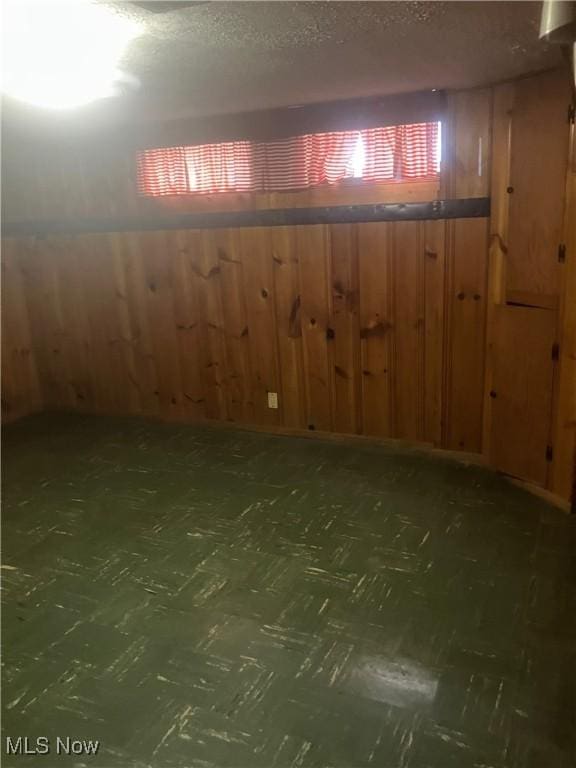 7718 Bertha Ave, Parma, OH 44129 - basement with wooden walls and a textured ceiling
