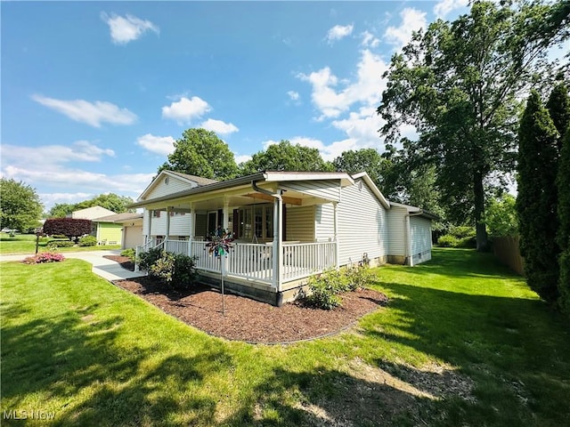1684 Morris St, Mineral Ridge, OH 44440 - view of side of property with covered porch, a yard, and a detached garage