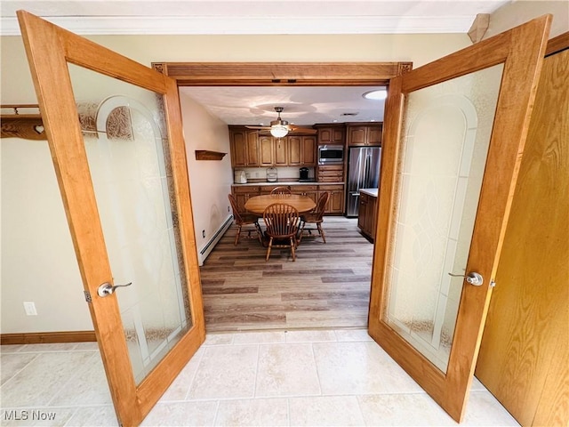 1684 Morris St, Mineral Ridge, OH 44440 - kitchen featuring stainless steel appliances, a baseboard radiator, crown molding, ceiling fan, and light tile patterned floors