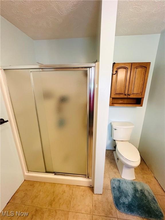 1684 Morris St, Mineral Ridge, OH 44440 - bathroom with a stall shower, tile patterned flooring, and a textured ceiling