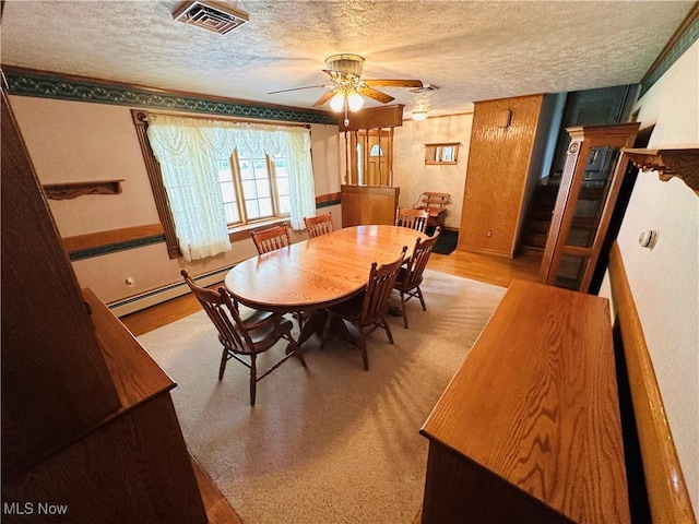 1684 Morris St, Mineral Ridge, OH 44440 - dining area featuring a textured ceiling, a baseboard radiator, and ceiling fan