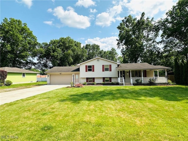 1684 Morris St, Mineral Ridge, OH 44440 - split level home featuring concrete driveway, a garage, and a porch