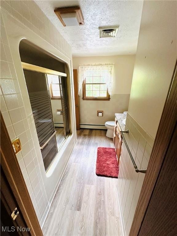 1684 Morris St, Mineral Ridge, OH 44440 - bathroom featuring vanity, a baseboard heating unit, wood finished floors, and a textured ceiling