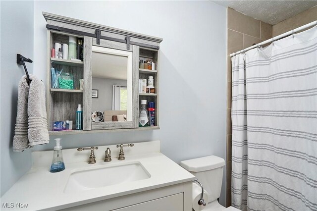 53 Joel Dr, Mogadore, OH 44260 - bathroom with vanity, a shower with shower curtain, and a textured ceiling