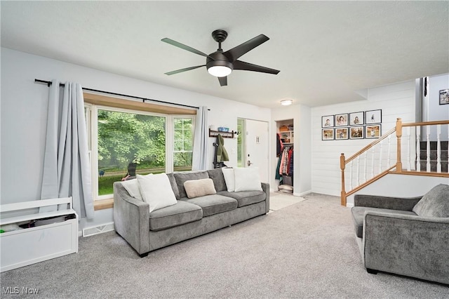 53 Joel Dr, Mogadore, OH 44260 - carpeted living room featuring ceiling fan and stairway