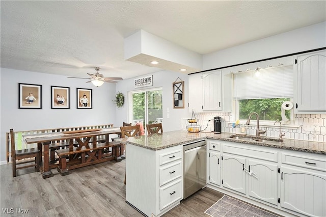 53 Joel Dr, Mogadore, OH 44260 - kitchen featuring dishwasher, a peninsula, white cabinets, a textured ceiling, and recessed lighting