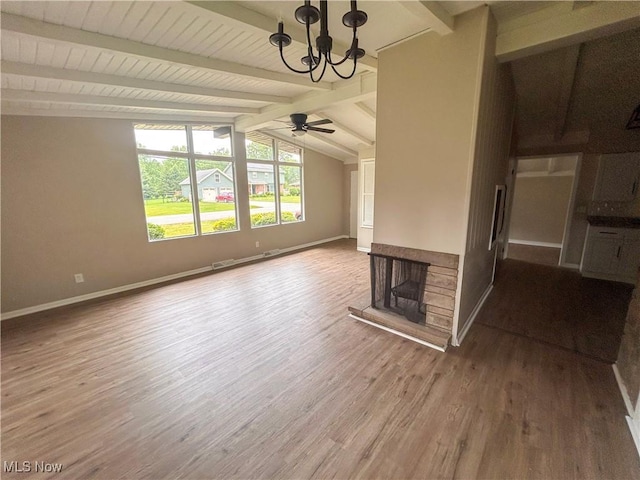 837 Pinecrest Rd, Girard, OH 44420 - unfurnished living room with a chandelier, wood finished floors, a stone fireplace, and ceiling fan