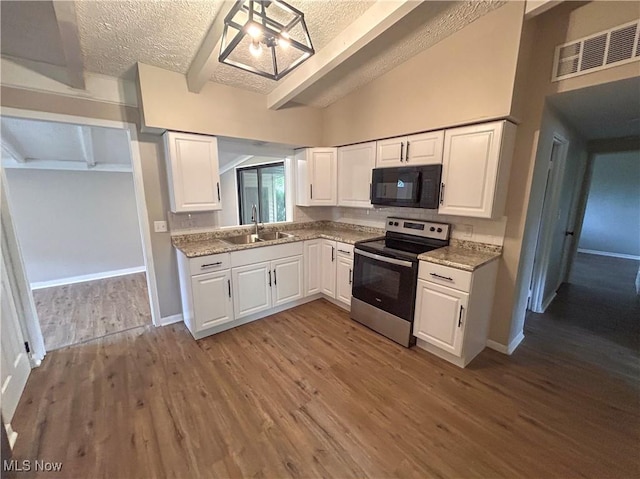 837 Pinecrest Rd, Girard, OH 44420 - kitchen featuring stainless steel range with electric cooktop, black microwave, a textured ceiling, white cabinetry, and wood finished floors
