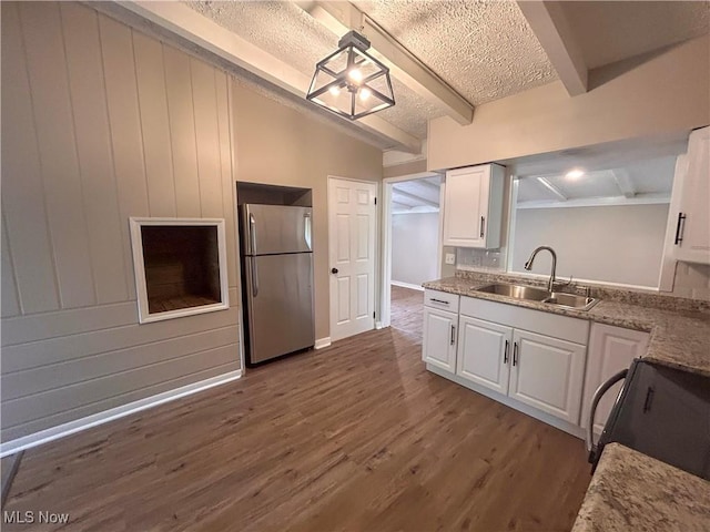 837 Pinecrest Rd, Girard, OH 44420 - kitchen with freestanding refrigerator, beamed ceiling, white cabinets, black range oven, and dark wood finished floors