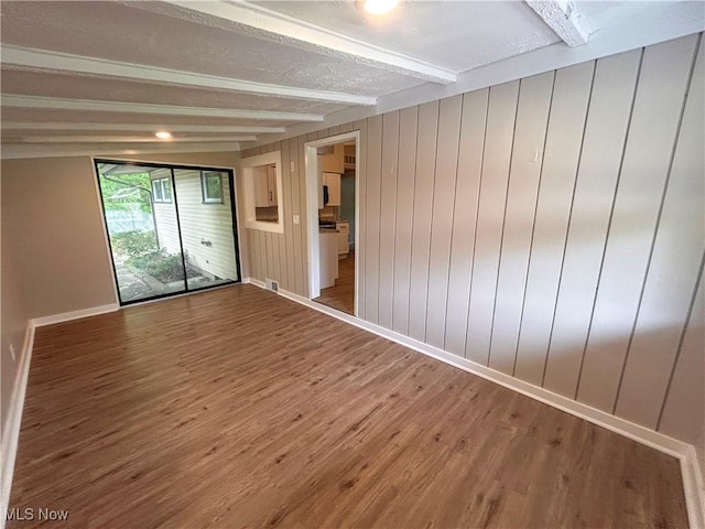 837 Pinecrest Rd, Girard, OH 44420 - empty room with beam ceiling and wood finished floors