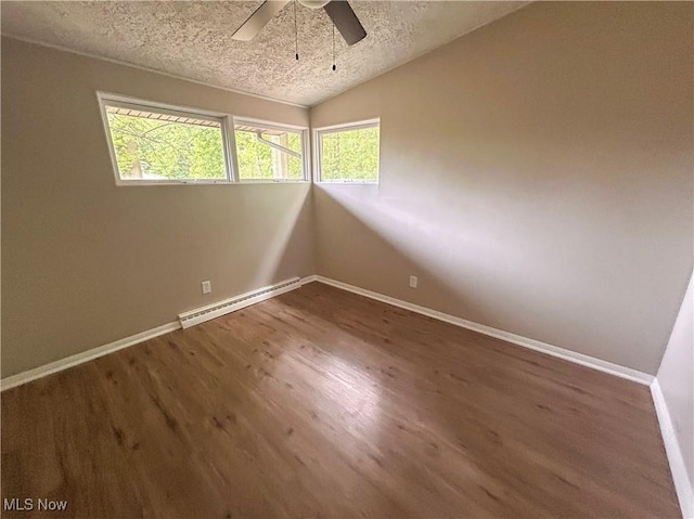 837 Pinecrest Rd, Girard, OH 44420 - spare room featuring baseboard heating, a textured ceiling, vaulted ceiling, ceiling fan, and wood finished floors