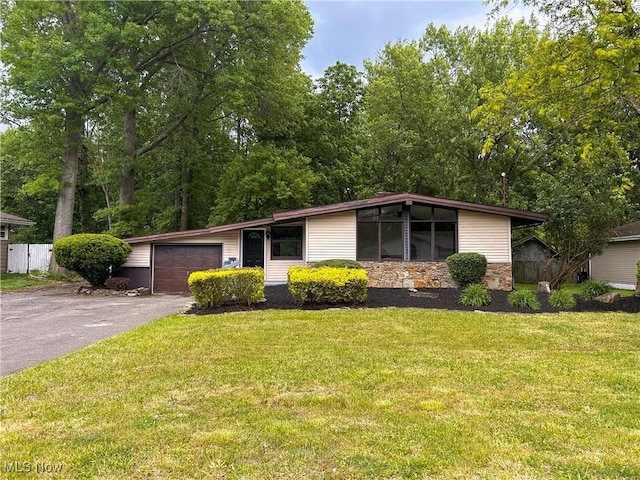 837 Pinecrest Rd, Girard, OH 44420 - mid-century home with stone siding, asphalt driveway, and an attached garage