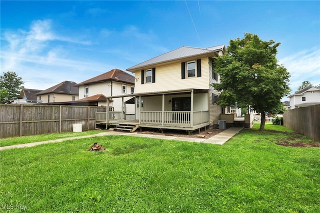 722 Clark St, Cambridge, OH 43725 - back of property with a fenced backyard, a wooden deck, and a metal roof