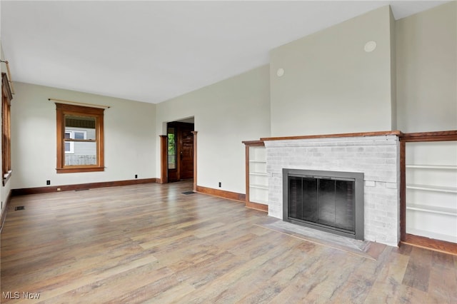 722 Clark St, Cambridge, OH 43725 - unfurnished living room with wood finished floors and a fireplace