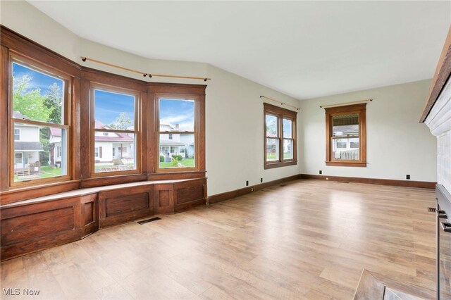 722 Clark St, Cambridge, OH 43725 - unfurnished living room featuring light wood finished floors, plenty of natural light, and a fireplace