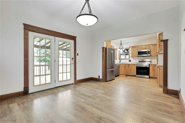 722 Clark St, Cambridge, OH 43725 - kitchen with appliances with stainless steel finishes, light wood-style floors, light countertops, and light brown cabinetry