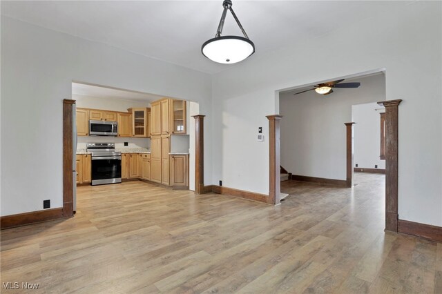 722 Clark St, Cambridge, OH 43725 - kitchen with appliances with stainless steel finishes, light wood-type flooring, ceiling fan, glass insert cabinets, and light countertops