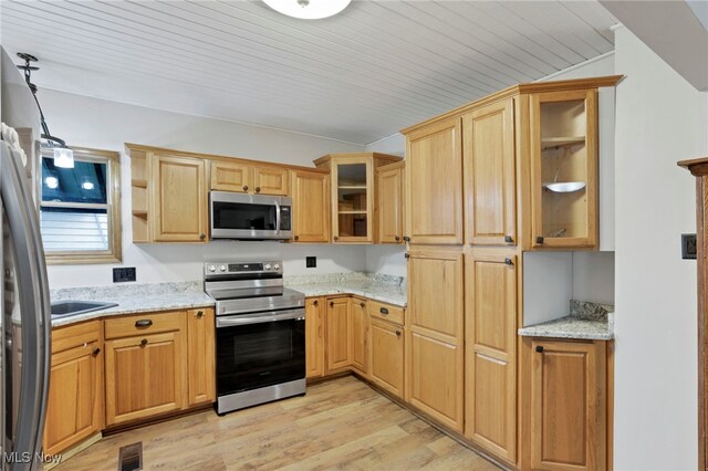 722 Clark St, Cambridge, OH 43725 - kitchen with appliances with stainless steel finishes, light wood-style floors, light stone counters, glass insert cabinets, and open shelves
