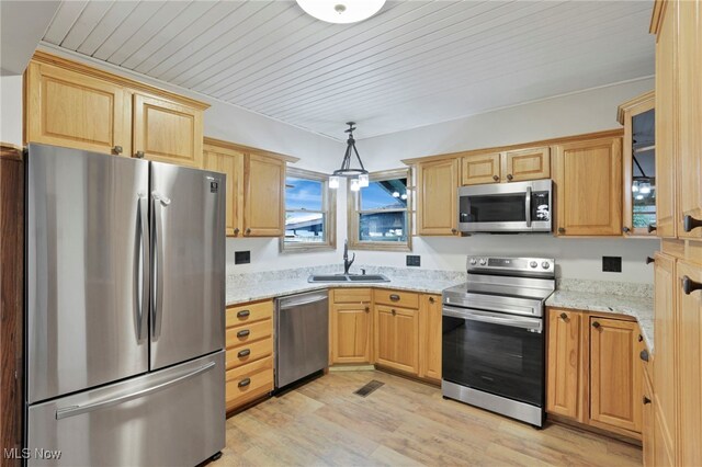 722 Clark St, Cambridge, OH 43725 - kitchen featuring appliances with stainless steel finishes, light wood-type flooring, glass insert cabinets, light stone counters, and light brown cabinets
