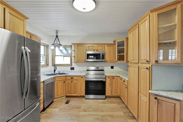 722 Clark St, Cambridge, OH 43725 - kitchen featuring appliances with stainless steel finishes, light wood finished floors, light stone countertops, glass insert cabinets, and pendant lighting