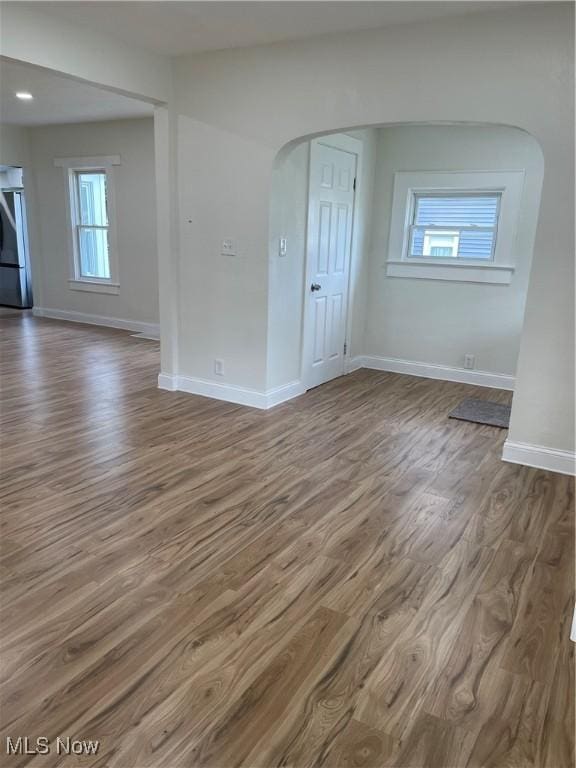124 W 29th St, Lorain, OH 44055 - spare room featuring wood finished floors and arched walkways