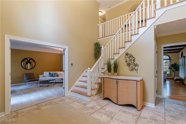 2008 E Highgate Ct, Hudson, OH 44236 - stairs featuring ornamental molding, a towering ceiling, and marble finish flooring