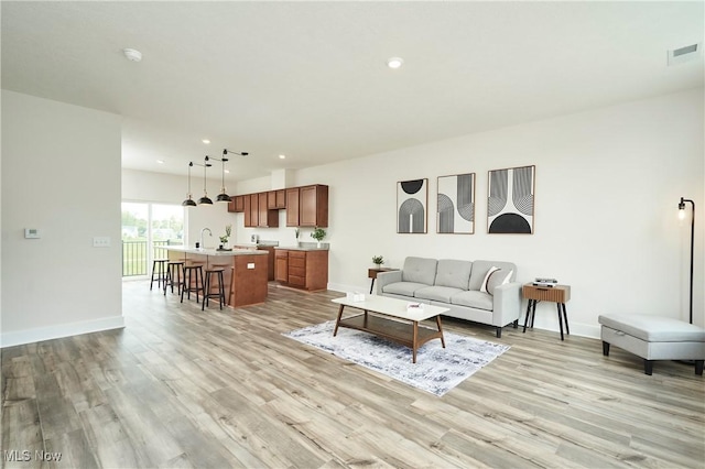 606 Mull Ave Unit 13, Akron, OH 44313 - living room with light wood-style floors and recessed lighting