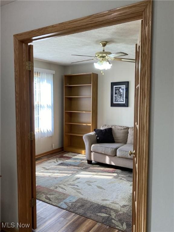 454 Lincoln Ave NW, Carrollton, OH 44615 - living area featuring wood finished floors, a textured ceiling, and a ceiling fan