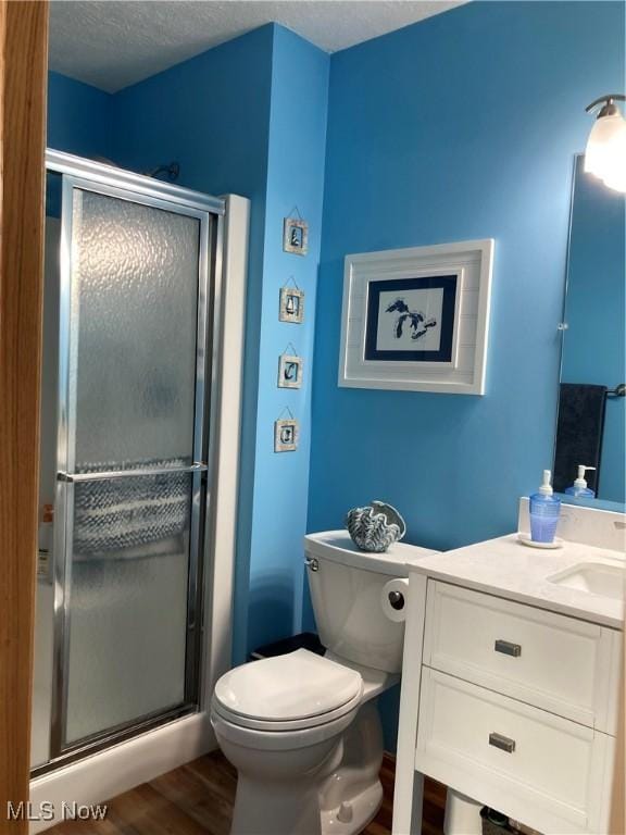 454 Lincoln Ave NW, Carrollton, OH 44615 - full bathroom with vanity, a stall shower, and wood finished floors