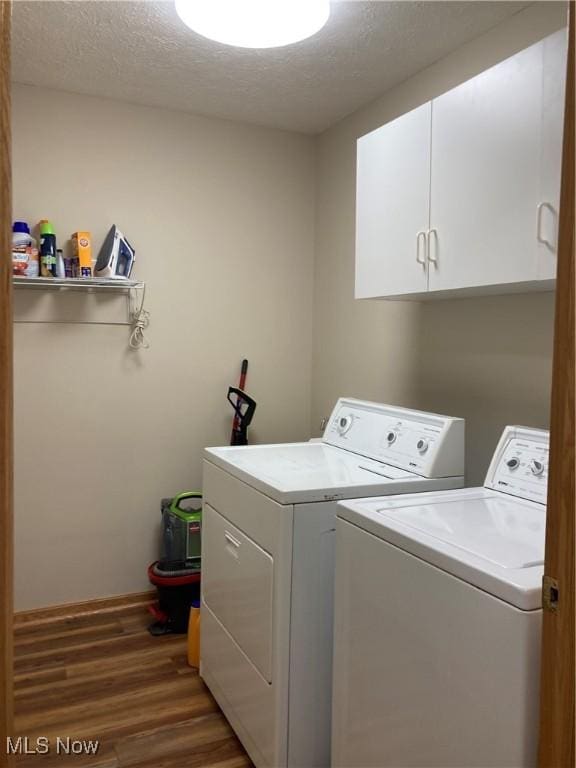 454 Lincoln Ave NW, Carrollton, OH 44615 - laundry area with cabinet space, washing machine and dryer, wood finished floors, and a textured ceiling
