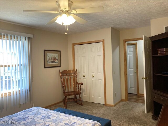 454 Lincoln Ave NW, Carrollton, OH 44615 - bedroom with a closet, carpet floors, a textured ceiling, and a ceiling fan