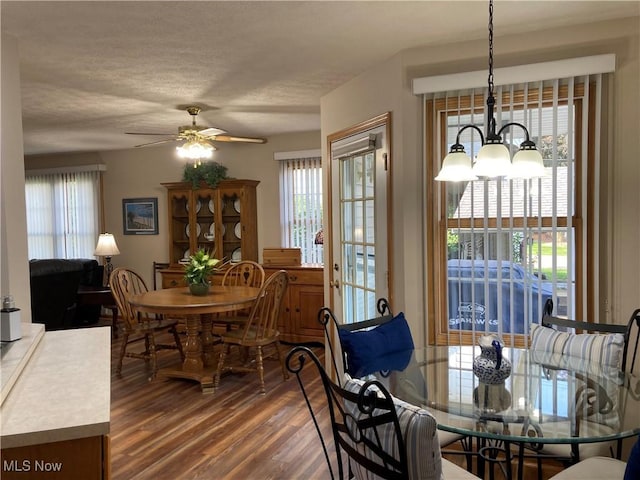 454 Lincoln Ave NW, Carrollton, OH 44615 - dining space with wood finished floors, a ceiling fan, a chandelier, and a textured ceiling