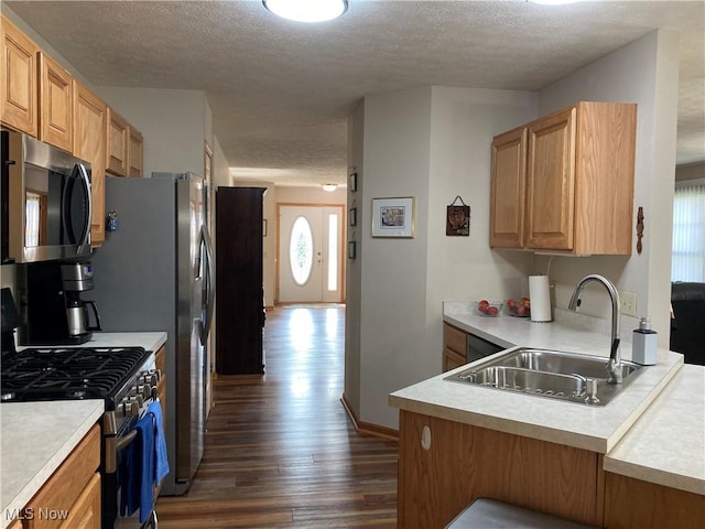 454 Lincoln Ave NW, Carrollton, OH 44615 - kitchen with stainless steel gas stove, dark wood-style floors, a textured ceiling, healthy amount of natural light, and light countertops