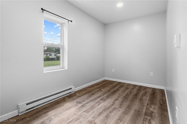 2914 Maple St, Norton, OH 44203 - spare room featuring baseboard heating and wood finished floors