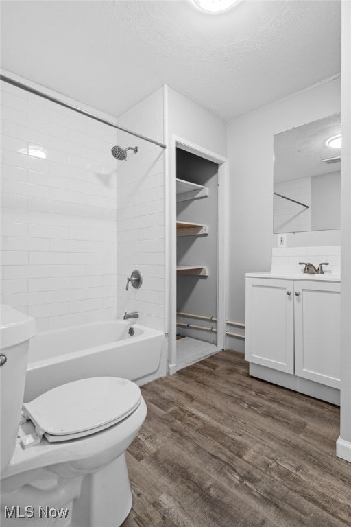 2914 Maple St, Norton, OH 44203 - bathroom with vanity, wood finished floors, shower / bathtub combination, and a textured ceiling