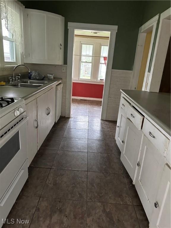 153 River St, Grantsville, WV 26147 - kitchen with white gas range, healthy amount of natural light, dishwashing machine, and white cabinetry