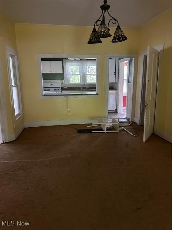 153 River St, Grantsville, WV 26147 - unfurnished dining area featuring plenty of natural light and dark carpet